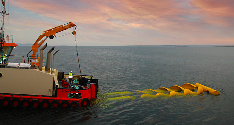 MV C-Odyssey, a multi-purpose workboat, deploying or retrieving a large, yellow, helical structure in the water
