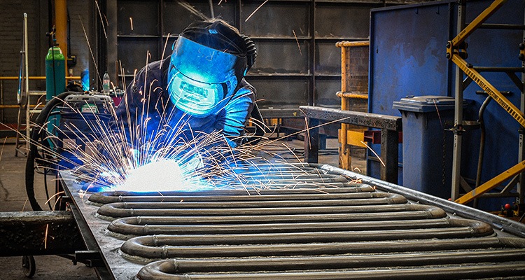 a welder performing welding work in a fabrication workshop