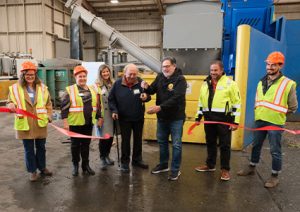 a ribbon-cutting ceremony held for the opening of a new waste management or recycling facility. 
