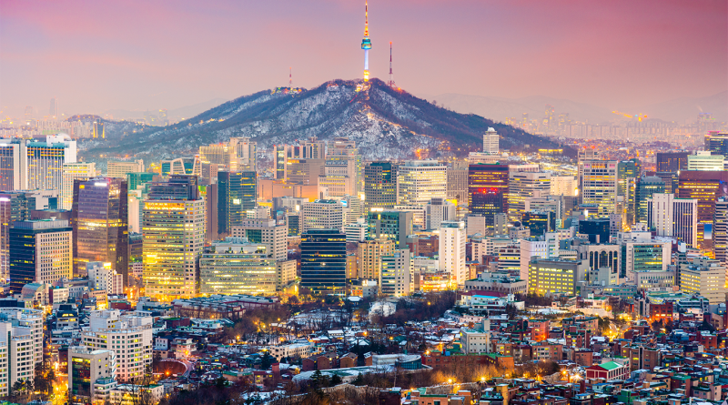 Seoul skyline at dusk with illuminated high rise buildings and Namsan Seoul Tower on a mountain, representing urban density and energy demand in South Korea