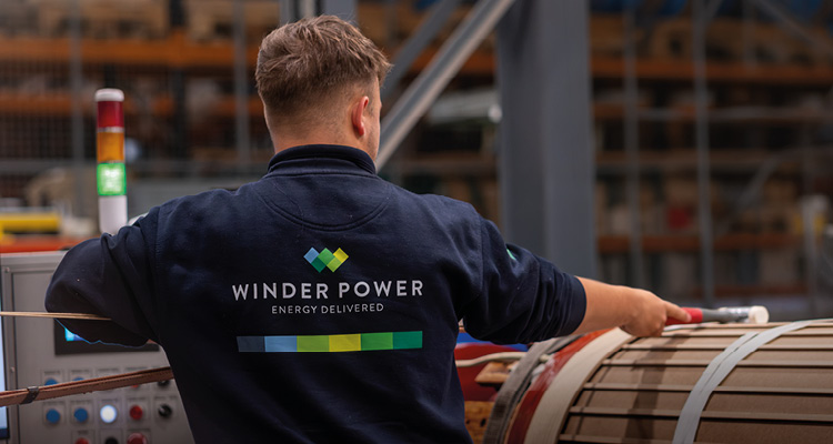 Winder Power employee wearing a branded navy blue sweater while working on a transformer project