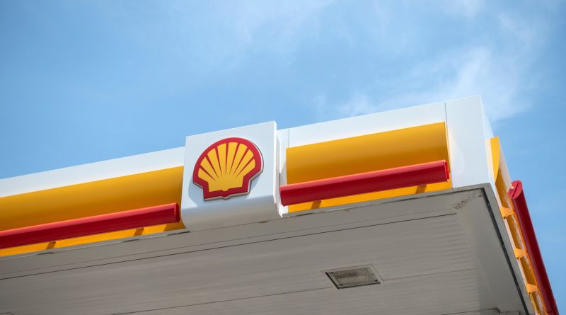 Solar panels and wind turbines representing Shell's $1.8 billion sale of Sprng Energy to Aditya Birla Renewables in India.