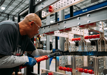 an assembler working on heavy-duty industrial electrical infrastructure