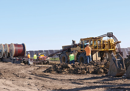 a Tesmec mechanical laying train performing all-in-one-pass trenching, cable deployment, and backfilling