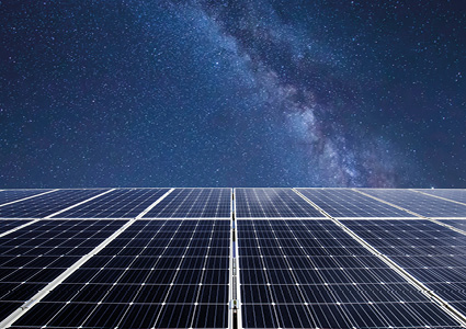 a vast array of solar panels set against a vibrant night sky featuring the Milky Way