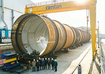 a large industrial steel column or pressure vessel under construction